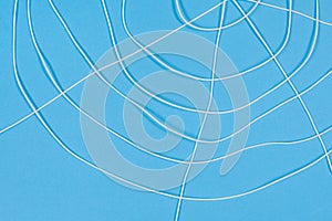 Abstract spiderweb, white threads on blue background