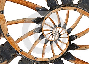Abstract spiral wooden wagon cannon wheel with black metal brackets, rivets. Wheel wooden spokes fractal background. Horse vehicle