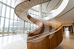 Abstract spiraling handrail of a wooden staircase