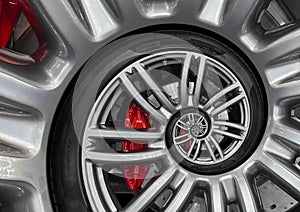 Abstract sport car spiral wheel rim with tire, brake disc. Automobile repetitive pattern background illustration. Car wheel and ti