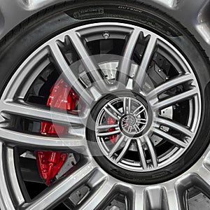 Abstract sport car spiral wheel rim with tire, brake disc. Automobile repetitive pattern background illustration. Car wheel and ti photo