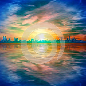 Abstract spring background gold sunset blue sky and silhouette of city