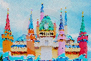 Abstract stained glass image of colorful cartoon colorful castle with blue sky.