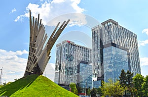 Abstract statue in front of the City Gate Towers, two class A office buildings located in Press Square of Bucharest, capital of