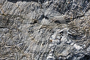 Abstract stone background - black, grey, dark stone texture - folded rocks