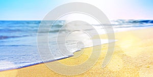 Abstract summer vacation background of blurred beach sand and sea waves