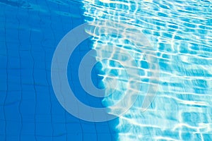 Abstract of sun reflected in the water of the swimming pool : Bl