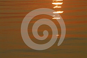 ABSTRACT- Sunrise Creates Orange Color for Ocean Water