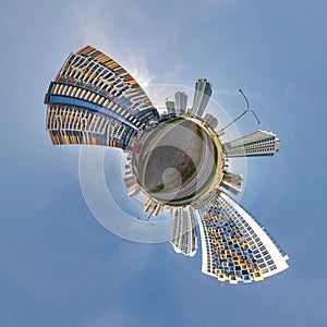 abstract swirling tiny planet spherical panorama of multi-storey buildings of skyscrapers of a residential complex in the form of