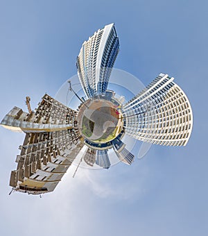 abstract swirling tiny planet spherical panorama of multi-storey buildings of skyscrapers of a residential complex in the form of