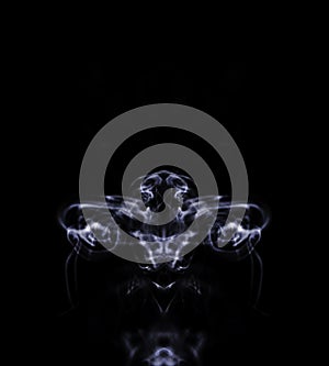 Abstract symetrical shaped smoke against black background