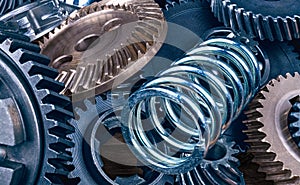 Steel coil spring and various gearwheels close-up