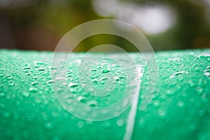 Abstract texture background of beautiful raindrop or water drops on  green-white umbrella surface