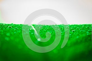 Abstract texture background of beautiful raindrop or water drops on green-white umbrella surface