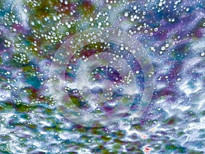 Abstract texture background view of a windshield in a car wash