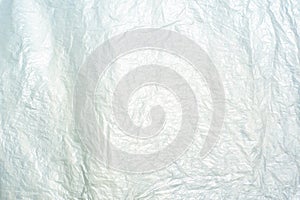 Abstract texture and background of wrinkled plastic sheet reflec to the light of sun photo