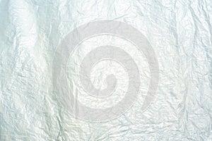 Abstract texture and background of wrinkled plastic sheet reflec to the light of sun