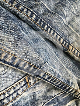 Abstract texture composition of blue vintage jeans.
