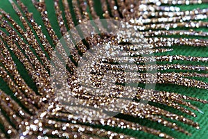 Abstract texture with gold spangles on a green background, similar to a leaf of a plant