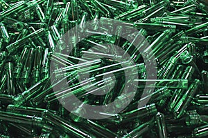 An abstract texture of green pet plastic preforms