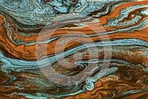 Abstract texture of mixing colors similar to marble stone in brown-blue tones.
