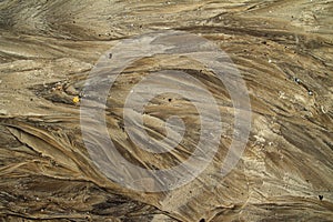 Abstract texture of a sandy beach after the rain.