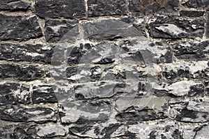 An abstract texture of wall. A medieval masonry from large grey stones