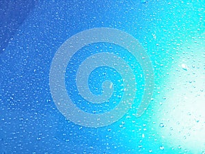 Abstract, texture, water droplets on car glass, image for blue background, rainy season concept, selectable focus.