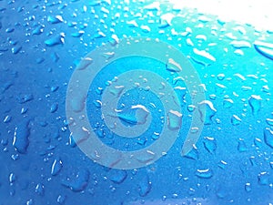 Abstract, texture, water droplets on car glass, image for blue background, rainy season concept, selectable focus.