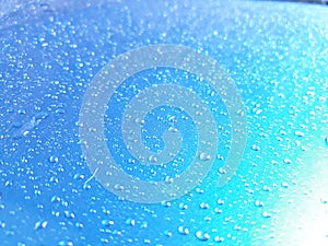 Abstract, texture, water droplets on car glass, image for blue background, rainy season concept, selectable focus.