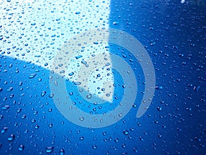 Abstract, texture, water droplets on car glass, image for blue background, rainy season concept, selectable focus.