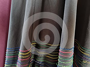Abstract textured hijab cloth background in gray and red with a combination of colored stripes