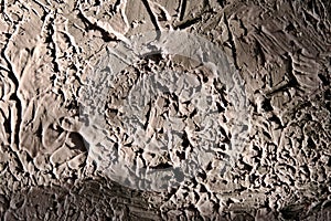 Abstract textured plaster putty brush strokes with light and shadow on wall background