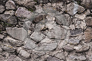 Abstract traditional stone wall pavement texture background. Bumpy textured stonewall made from flagstone and slabstone
