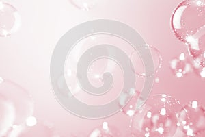 Abstract, transparent shiny soap bubbles float on pink background. Beautiful pink valentine` day concept.