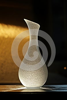Abstract vase of unusual shape made of frosted glass photo