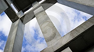 An abstract view of a concrete stucture reaching to the sky.