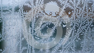 Abstract view of frost on the window surface. Blue crystal frosty texture. Cold winter background.