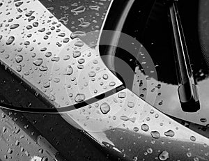 Abstract view of a german made sports car bodywork, seen after a rain shower.