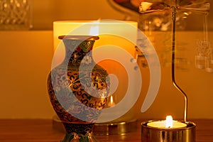 Abstract view of an interior candle lit shelf containing a spinning mobile with musical notes