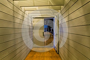 Abstract view of interior corridor with lights and open doors