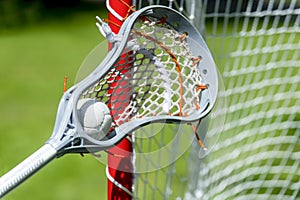 Abstract view of a lacrosse stick scooping up a ball