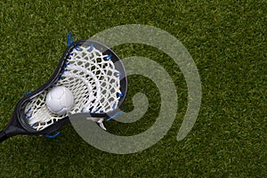 Abstract view of a lacrosse stick scooping up a ball