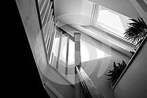 Abstract view of a new loft conversion showing the stairwell and skylight window leading to the first floor.