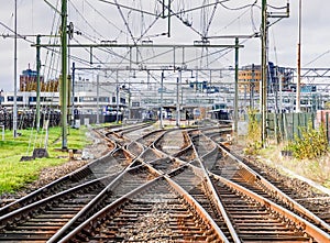 An abstract view of railway tracks leading to a busy station.