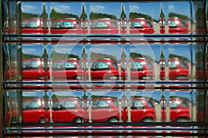 Abstract View of a Red Car seen through a Glass Brick.