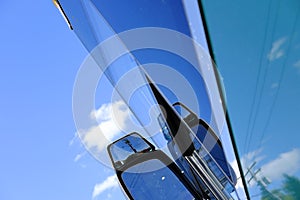 Abstract view of a tour bus seen from the drivers side.