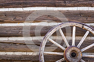 Abstract of Vintage Antique Log Cabin Wall and Wagon Wheel.