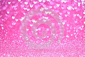 Abstract vintage background from glitter pink bokeh lights in the shape of a heart, blurred background