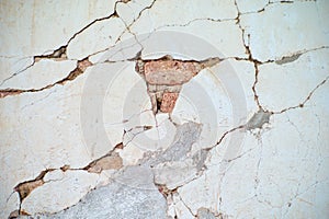 Abstract vintage texture and background of crack and broken plastered cement surface on the brickwork wall